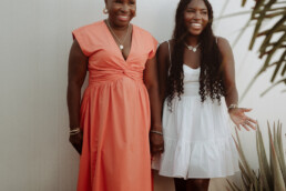 family portrait sint maarten mother and daughter standing on wall laughing
